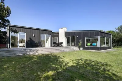 a modern house with a black exterior and a yard at LF299-Vestervig-Ingersvej-21 in Vestervig
