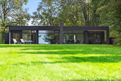 a black house with a large yard at LF14141-Spottrup-Fjordvej-25 in Spottrup