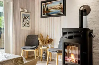 a living room with a fireplace and two chairs at LF14223-Roslev-Livovej-9 in Roslev