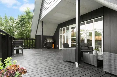 a deck with chairs and tables on a house at LF11122-Struer-Plantagevej-22 in Struer