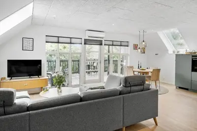 a living room with a couch and a tv at LF11122-Struer-Plantagevej-22 in Struer