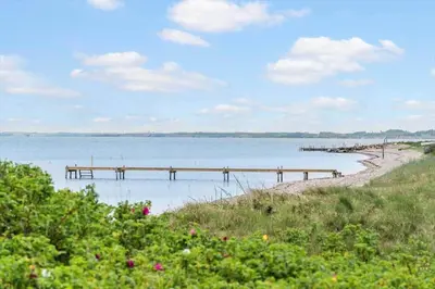 a pier on the water with a beach at LF10058-Thyholm-Fyrrevej-17 in Thyholm