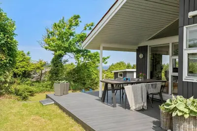 a patio with a table and chairs on a house at LF11107-Struer-Skovvej-7 in Struer