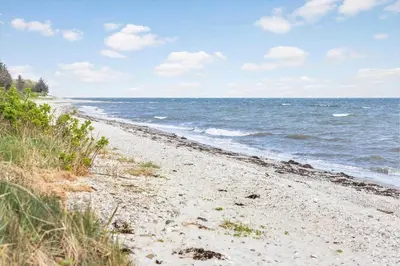 a sandy beach with the ocean in the background at LF13172-Nykobing-M-Strandvaenget-76 in Ejerslev