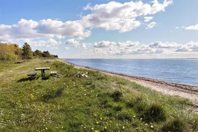 a bench sitting on the side of a beach at LF13172-Nykobing-M-Strandvaenget-76 in Ejerslev