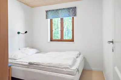 a bed in a room with a window at LF11597-Struer-Plantagevej-97 in Struer