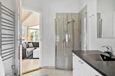 a bathroom with a shower and a sink in a room at LF10210-Thyholm-Skovstien-10 in Thyholm