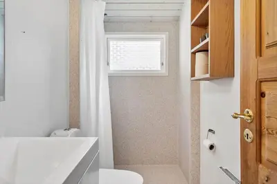 a bathroom with a white toilet and a window at LF11108-Struer-Barsidalvej-8 in Struer