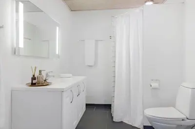 a white bathroom with a toilet and a sink at LF14211-Roslev-Vile-Vestergardvej-34-Lejl-A-tv in Roslev