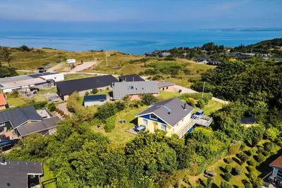 an aerial view of a house on a hill next to the ocean at LF11111-Struer-Granvej-11 in Struer