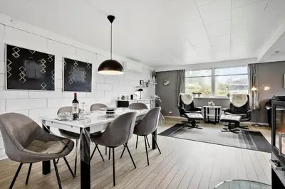 a living room with a dining table and chairs at LF14062-Roslev-Stranddalen-62 in Roslev