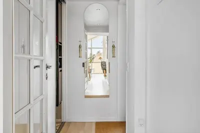 a hallway with a door and a mirror at LF10229-Thyholm-Skovstjernevej-9 in Thyholm