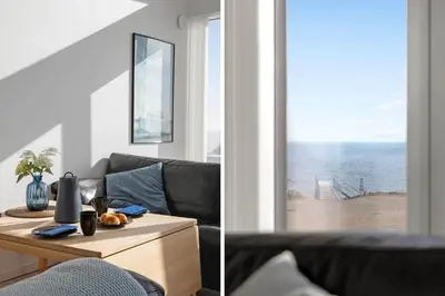 a living room with a couch and a view of the ocean at LF10214-Thyholm-Havnefronten-14 in Thyholm