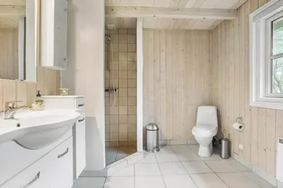 a bathroom with a toilet and a sink and a shower at LF10307-Hurup-Thy-Traelobervej-7 in Sønder Ydby