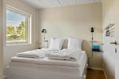 a white bed in a room with a window at LF12086-Vinderup-Vigen-86 in Vinderup