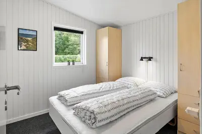 two beds in a white room with a window at LF11103-Struer-Blabaervej-3 in Struer