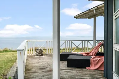 a porch with a bed and a view of the ocean at LF12183-Vinderup-Avej-28 in Vinderup