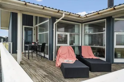 a screened in deck with a table and chairs at LF12183-Vinderup-Avej-28 in Vinderup