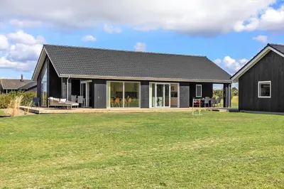 a black house with a large yard in front of it at LF12003-Spottrup-Molleparken-32 in Spottrup