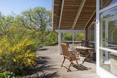 a porch of a house with a table and chairs at LF21631-Spottrup-Vibevej-3 in Spottrup