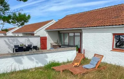 a house with a chair and a table and a chair at Beautiful Home In Pandrup With Wifi in Pandrup