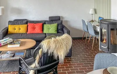 a living room with a couch with colorful pillows at Beautiful Home In Pandrup With Wifi in Pandrup