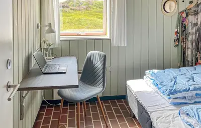 a bedroom with a desk with a laptop and a bed at Beautiful Home In Pandrup With Wifi in Pandrup