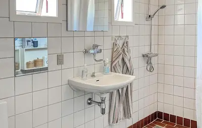 a white bathroom with a sink and a mirror at Beautiful Home In Pandrup With Wifi in Pandrup