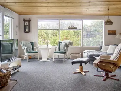 a living room with a couch and chairs and a tv at 6 person holiday home in Thisted in Thisted