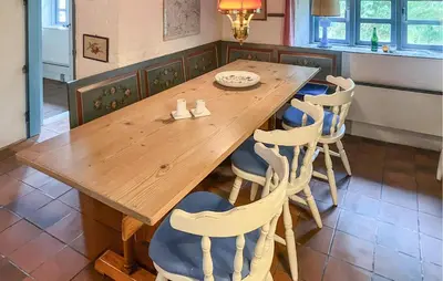 a wooden table and chairs in a kitchen at Gorgeous Home In Vemb With Wifi in Vemb