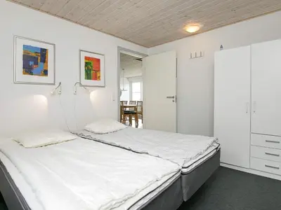 a bedroom with a bed and white walls at 10 person holiday home in Ranum in Ranum