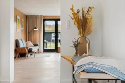 a room with a bed and a living room at BL1116-Blokhus-Bloksbjerg-24 in Blokhus