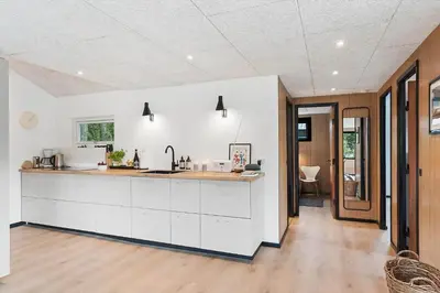 a kitchen with white cabinets and a counter top at BL1116-Blokhus-Bloksbjerg-24 in Blokhus