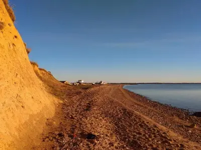 a dirt road next to a body of water at 6 person holiday home in Øster Assels in Øster Assels