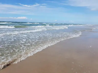 a beach with waves coming in from the ocean at Welcoming 6 person holiday home in Blokhus in Blokhus