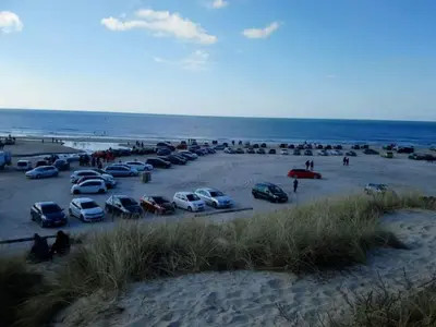 a group of cars parked in a parking lot at the beach at Welcoming 6 person holiday home in Blokhus in Blokhus