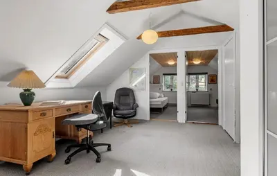 an attic office with a desk and a bedroom at Pet Friendly Home In Farsø With House A Panoramic View in Farsø
