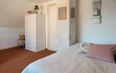 a bedroom with a bed and a white cabinet at Lovely Home In Karby With Wifi in Karby