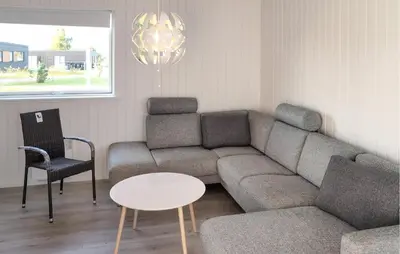 a living room with a couch and a table and chairs at 3 Bedroom Nice Home In Løgstrup in Løgstrup
