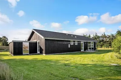 a black house with a large yard at JB130-Fjerritslev-Thorup-Strandvej-274 in Fjerritslev