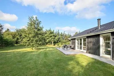 a house with a large yard with a patio at JB130-Fjerritslev-Thorup-Strandvej-274 in Fjerritslev