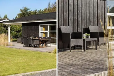 a patio with a table and chairs on a deck at JB241-Fjerritslev-Lyngstien-25 in Fjerritslev