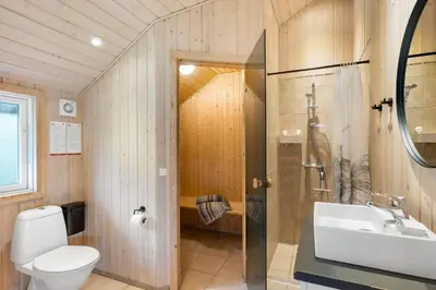 a bathroom with a toilet and a sink and a shower at JB232-Brovst-Kronvildtvej-20 in Brovst