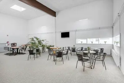 an empty room with tables and chairs and a tv at JB181-Brovst-Strandvejen-150-Lejl-142 in Brovst