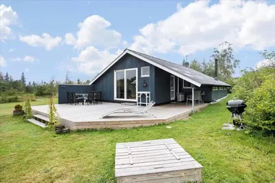 a blue house with a deck and a grill at JB578-Fjerritslev-Hasselvej-57 in Fjerritslev