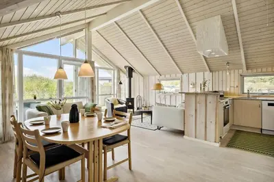 a kitchen and dining room with a table and chairs at JB765-Brovst-Sletten-20 in Brovst