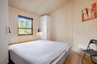 a bedroom with a bed in a room with a window at JB193-Fjerritslev-Blabaerstien-78 in Fjerritslev