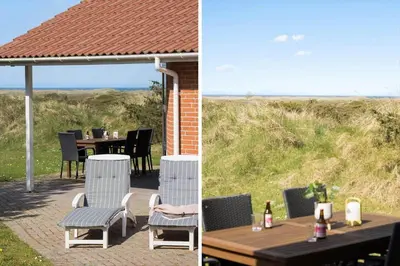 a patio with a table and chairs with a view of the beach at JB290-Fjerritslev-Mollebosletten-41 in Fjerritslev