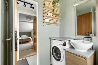 a bathroom with a washing machine and a sink at JB183-Frostrup-Svenstibakkevej-70 in Frøstrup
