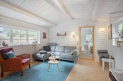 a living room with a couch and a table at JB160-Fjerritslev-Skovstien-7 in Fjerritslev